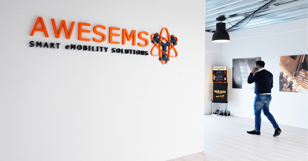 Het oude logo van Awesems hangt aan de muur. Een collega belt.
